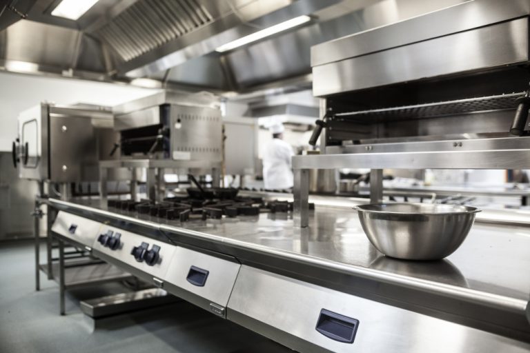 A well-equipped restaurant kitchen with spotless surfaces and equipment