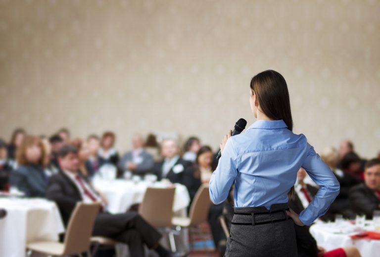 female speaker at a conference