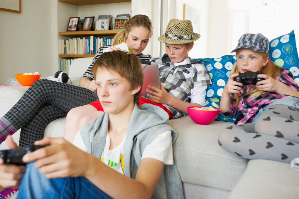 Teenage friends playing video games at home