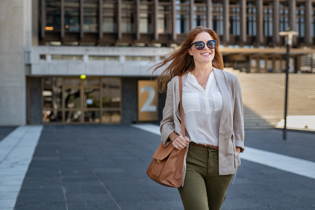 business woman wearing glasses walking to work